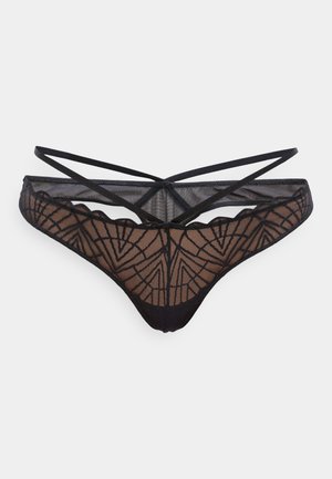 Thong din dantelă neagră cu model geometric, material transparent, bretele înguste și un design cu margine ondulată. Spatele prezintă detalii cu bretele încrucișate.