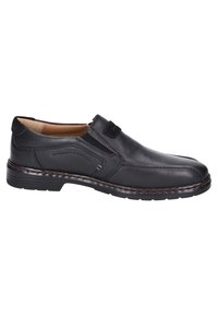 Scarpa slip-on in pelle nera con pannelli elastici laterali, punta arrotondata e cuciture dettagliate. Suola in gomma con tacco rialzato.