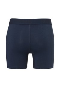 Navy blue boxer shorts with a soft texture, featuring a wide waistband with a discreet brand logo, and a close-fitting design.