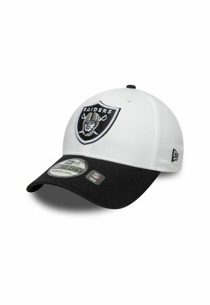 White baseball cap with a black brim, featuring an embroidered Raiders logo on the front and a New Era logo on the side.