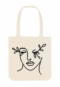 Canvas tote bag in off-white met een minimalistische zwarte lijntekening van een gezicht en bladeren. Beschikt over twee stevige handvatten voor gemakkelijk dragen.