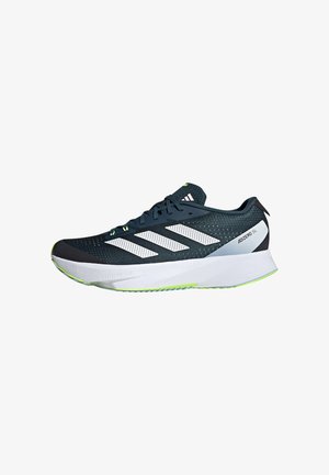 Running shoe with dark blue mesh upper, white three-stripe design, and green accents. Features a thick white midsole and textured outsole.