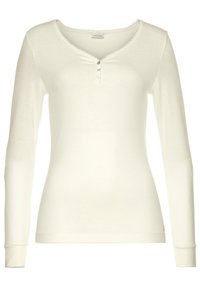 Long-sleeve white ribbed top with a rounded neckline, button detail at the front, and a textured finish. Features a scalloped edge at the collar.
