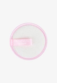 Disco exfoliante redondo con superficie texturizada blanca y borde rosa suave, con una etiqueta rosa que dice "brush works EXFOLIATE".