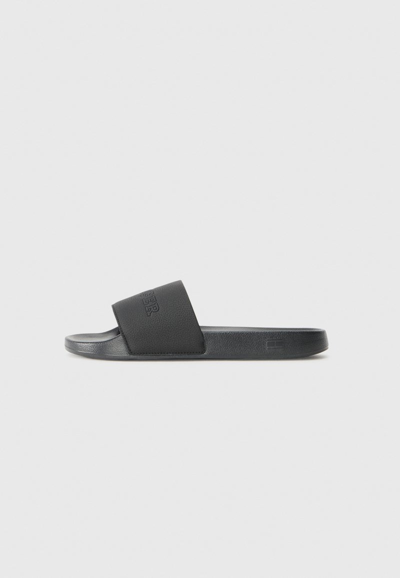 Black slide sandal with a textured strap and smooth footbed. Features a subtle logo on the strap. Made from durable synthetic material.