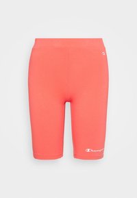 Korálově růžové sportovní šortky do půli stehen s elastickým pasem, s bílými logy Champion na levé stehně a pravém boku.