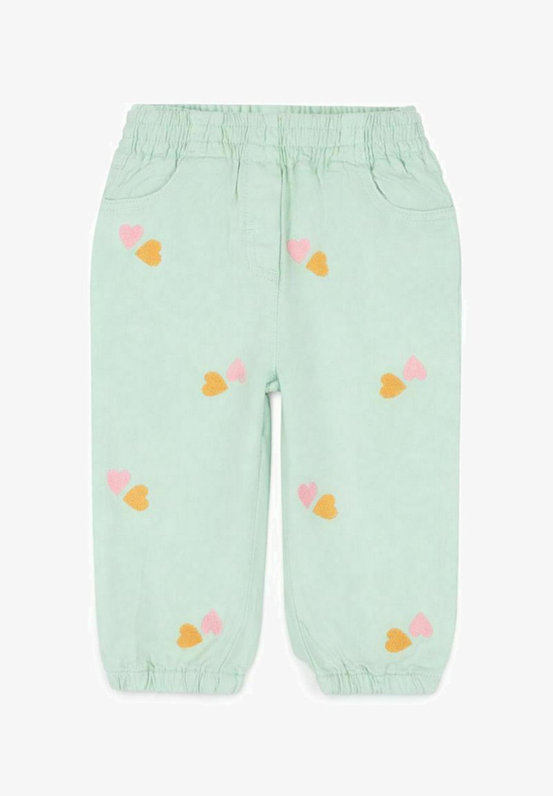 Pantalon vert clair à taille élastique avec des poignets élastiques, décoré de petits motifs de cœurs rose et orange dispersés sur le tissu.