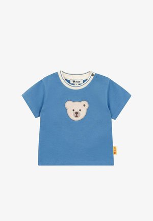Blaues Baumwoll-T-Shirt mit kurzen Ärmeln, rundem Ausschnitt und cremefarbenem Besatz. In der Mitte befindet sich ein aufgesticktes Bären-Gesicht. Etikett an der Seite.