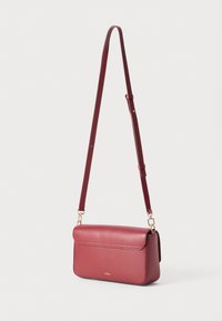 Structured crossbody bag in deep burgundy leather, featuring a gold-tone clasp and adjustable strap, with a smooth textured finish.