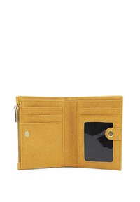 L'interno del portafoglio in tessuto giallo presenta scomparti per carte, una tasca trasparente per l'ID e una chiusura con zip. Materiale testurizzato con dettagli di cucitura discreti.