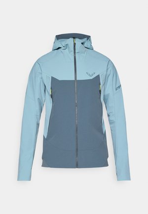 Meeste kerge jope sinistes toonides, millel on tõmblukk esiosas, kaks tõmblukuiga taskut, hingavad võrkpaneelid ja kapuuts.