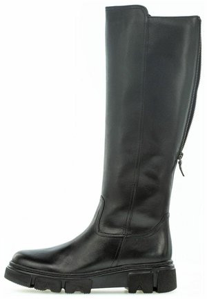 Botte noire haute en cuir avec semelle épaisse et fermeture éclair arrière, conçue pour un usage décontracté ou extérieur.