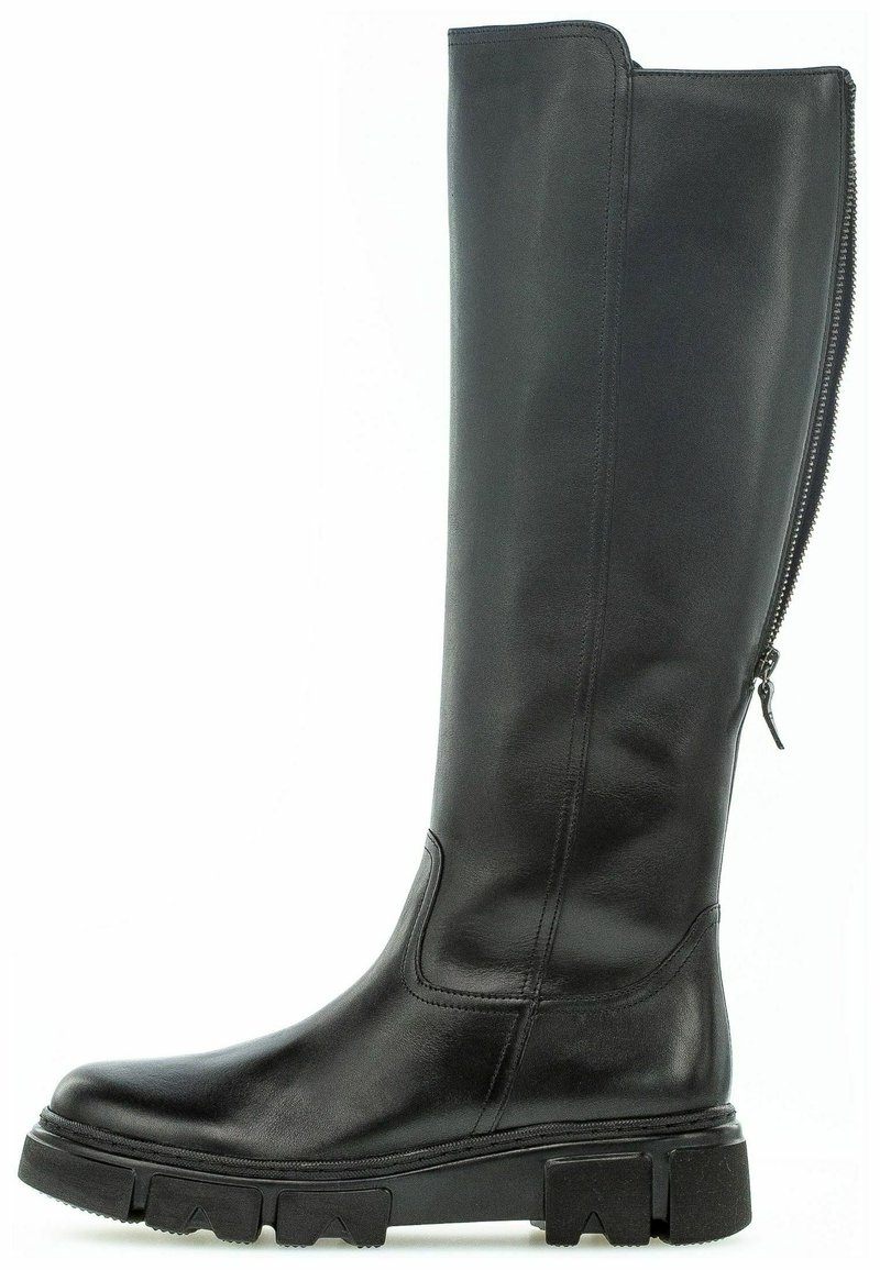 Botte noire haute en cuir avec semelle épaisse et fermeture éclair arrière, conçue pour un usage décontracté ou extérieur.