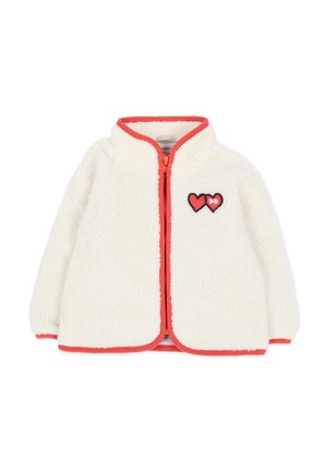 Witte fleecejas met rode bies en rits, met twee rode hartpatches op de linkerborst, één met ogen.