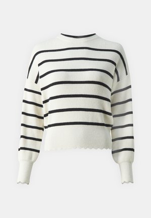 Valge ribaga sviiter mustade horisontaalsete triipudega, ümmargune kaelus ja laineline äär. Omab pikka varrukat kergete puhvitud õlgadega.