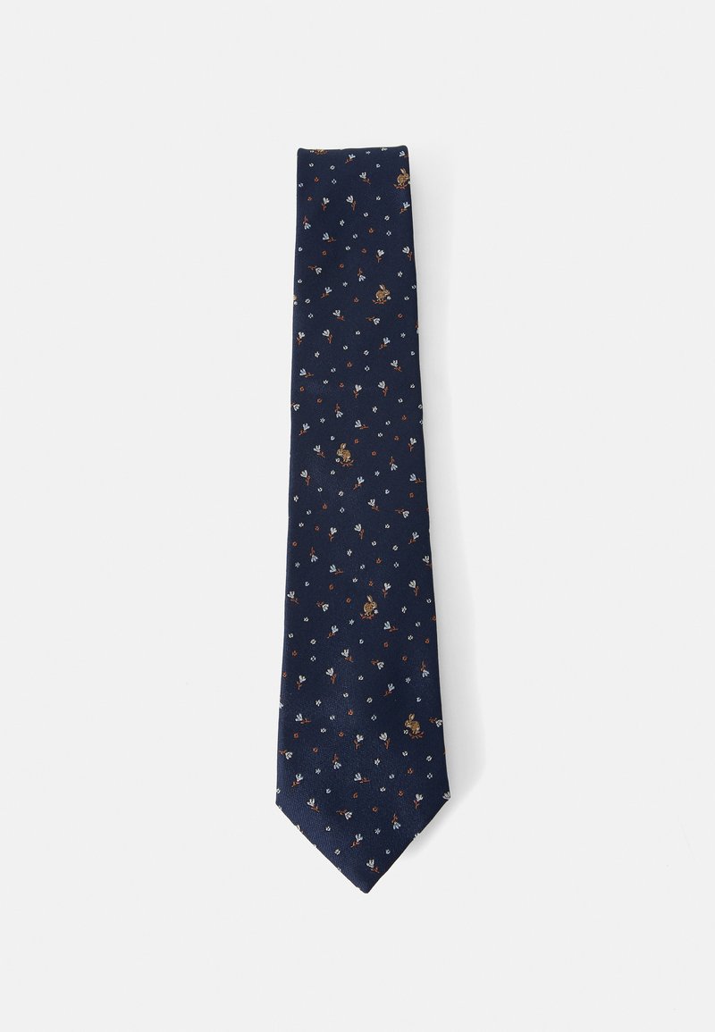 Marineblå slips med et gjentatt blomstermotiv og dyremotiv i beige, hvite og røde nyanser. Glatt stoff med spiss tuppdesign.