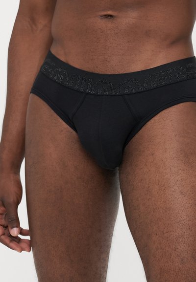Schwarze Baumwollunterhosen mit einem strukturierten Bund. Merkmale sind ein taillierter Schnitt, glattes Material und verstärkte Nähte.