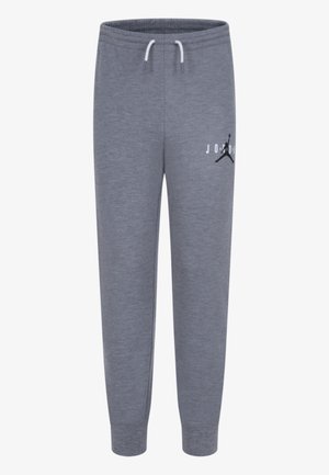 Pantalon de survêtement gris avec taille élastique, cordons blancs, chevilles resserrées et logo Jumpman noir avec le texte "JORDAN" sur la cuisse gauche.