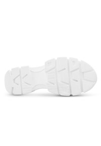 Sole di sneakers in gomma bianca con un motivo testurizzato, che include forme rettangolari e triangolari per la trazione e la presa.