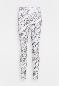 Leggings ajustés avec un motif en peau de serpent blanc et gris. Fabriqués en matériau extensible et lisse, avec une taille haute et sans coutures visibles.