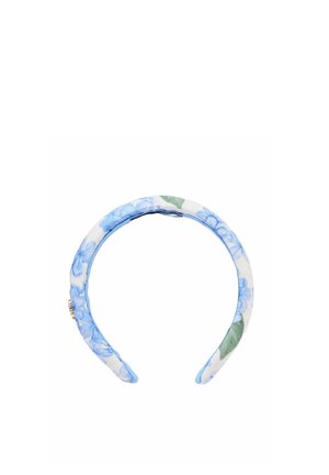 Fascia imbottita in tessuto con motivo floreale blu e foglie verdi su sfondo bianco, con un piccolo dettaglio decorativo dorato su un lato.