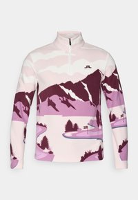 Pullover in fleece di colore rosa chiaro con grafica di una montagna viola e un fiume. Presenta un colletto con zip a metà e un piccolo logo sul petto.