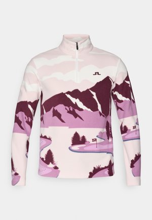 Pull en polaire rose clair avec un graphisme de montagne violette et de rivière. Présente un col zippé mi-hauteur et un petit logo sur la poitrine.