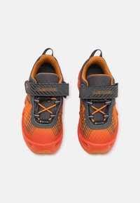 Chaussures Lowa en orange vif et gris, avec une texture respirante, une sangle ajustable et des accents réfléchissants sur un design épuré.