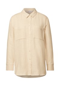 Krémová košile na knoflíky vyrobená z texturované látky, s límečkem, dvěma předními kapsami a dlouhými rukávy.