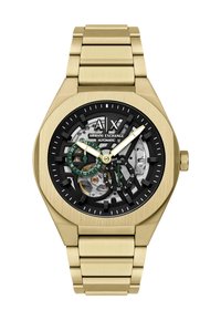 Złoty zegarek na rękę Armani Exchange z odsłoniętym czarnym i srebrnym automatycznym mechanizmem, podzielonymi na mniejsze tarcze z zielonymi akcentami oraz bransoletą z metalowych ogniw.