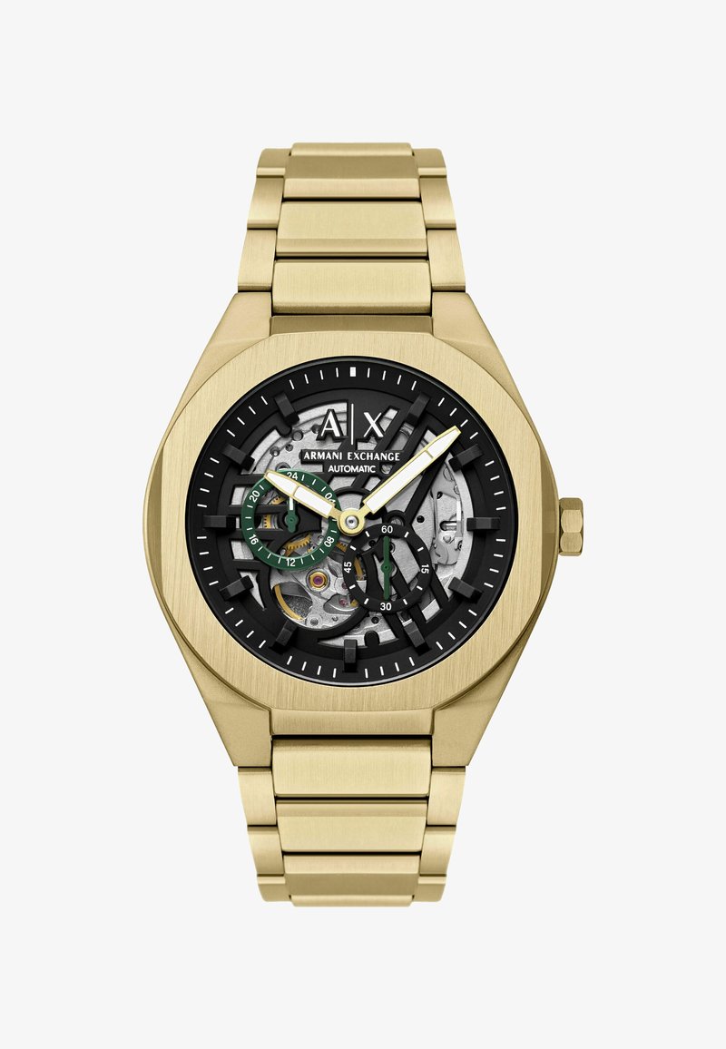 Złoty zegarek na rękę Armani Exchange z odsłoniętym czarnym i srebrnym automatycznym mechanizmem, podzielonymi na mniejsze tarcze z zielonymi akcentami oraz bransoletą z metalowych ogniw.