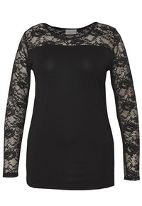 Haut noir avec de longues manches en dentelle, présentant un corps noir uni et des détails en dentelle florale. Encolure ronde au toucher doux.