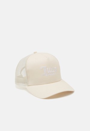 Casquette trucker beige avec dos en mesh et logo brodé blanc « Juicy Couture » sur le panneau avant sur fond blanc.