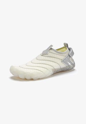 Slip-on shoe in light gray and white. Textured upper with quilted pattern, rubber sole with rounded grip pods, and gray accent detailing.