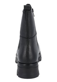 Mustat nilkkurit, joissa on teksturoitu nahka, paksu pohja, takana vetoketju ja vetotappi ylhäällä, kuvattu takanäkökulmasta.