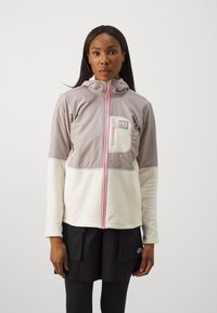 Ελαφρύ μπουφάν με γκρι απαλό πανί στην πάνω πλευρά, κρεμ φλις στο κάτω μέρος, μια μπροστινή τσέπη και ροζ λεπτομέρειες κατά μήκος του φερμουάρ και τ�ου ρέλι.
