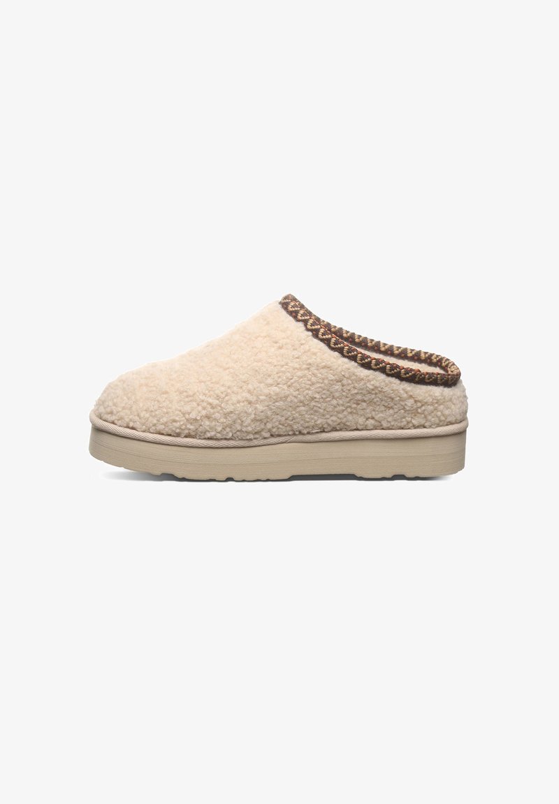 Cream-colored slipper made of textured fabric, featuring a brown patterned trim along the top edge and a light-colored rubber sole.