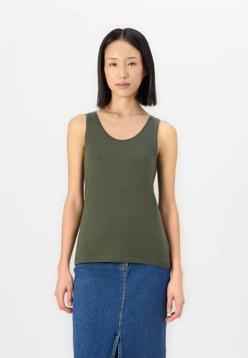 Olive green sleeveless tank top in soft cotton with a rounded neckline, paired with a blue denim skirt featuring a front slit.