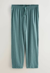 Pantalon de détente côtelé couleur turquoise clair avec une ceinture élastique et un cordon de serrage ajustable, présenté à plat sur un fond clair.