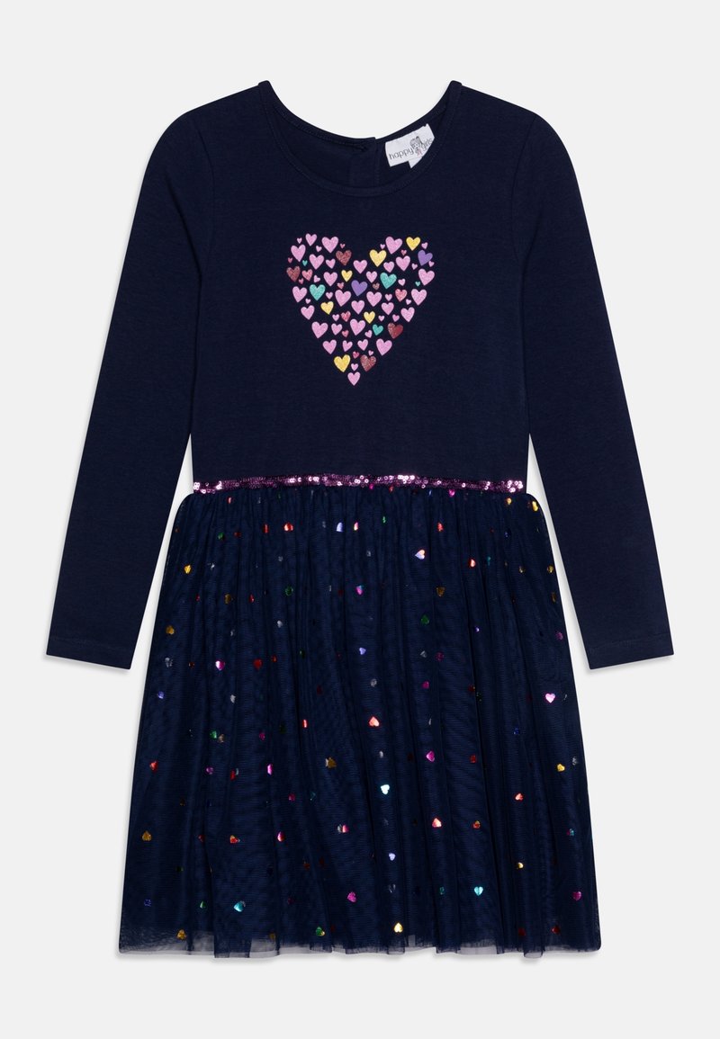 Námořnické šaty s dlouhým rukávem, s tělem zdobeným víc saborovými flitry ve tvaru srdce a sukní z tulového materiálu, která je zdobena iridescentními srdíčkovými akcenty.