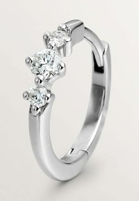 Anillo de plata con tres diamantes claros, de corte redondo, en engastes de garra, banda lisa con acabado pulido, diseño minimalista, forma elegante.