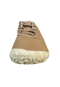 Tan sportieve schoen met textuur op de rubberen zool, vetersluiting en een glad bovenwerk. Bevat een kenmerkend looppatroon op de buitenzool.