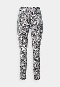 Höga leggings med ett svartvitt blommönster och mintgröna accenter längs sidorna. Tillverkade av flexibelt, texturerat material.