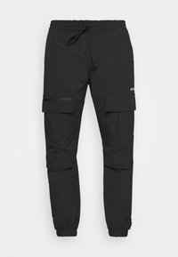 Pantalon cargo noir avec taille et poignets élastiques, fermeture à cordon de serrage, et plusieurs poches à rabat sur les cuisses et les genoux.