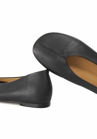 Black leather ballet flats with a rounded toe, smooth texture, and a small decorative cutout at the front. Simple, flat sole design.