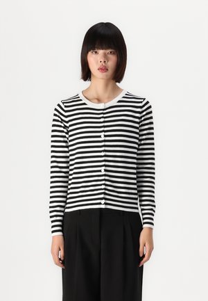 Black and white striped cardigan with long sleeves, round neckline, and white buttons down the front; paired with black pants.