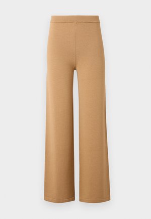 Wide-leg, beige pants made from a soft, stretchy fabric, featuring a high elastic waistband and clean, simple seams.
