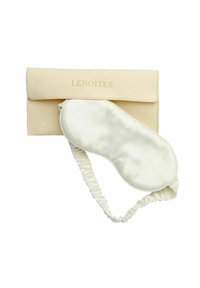 Siden sömnmask i vit med rynkad elastisk band, förvarad i ett beige tygpås med "LENOITES" präglat i guld.