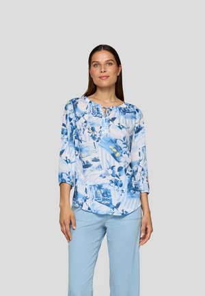 Light blue floral blouse with a round neckline, three-quarter sleeves, and a button placket. Patterns include flowers and scenic prints.