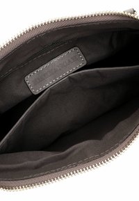 Gray fabric clutch bag with a zip closure, featuring a smooth interior, a card pocket, and a stitched label with minimal hardware details.